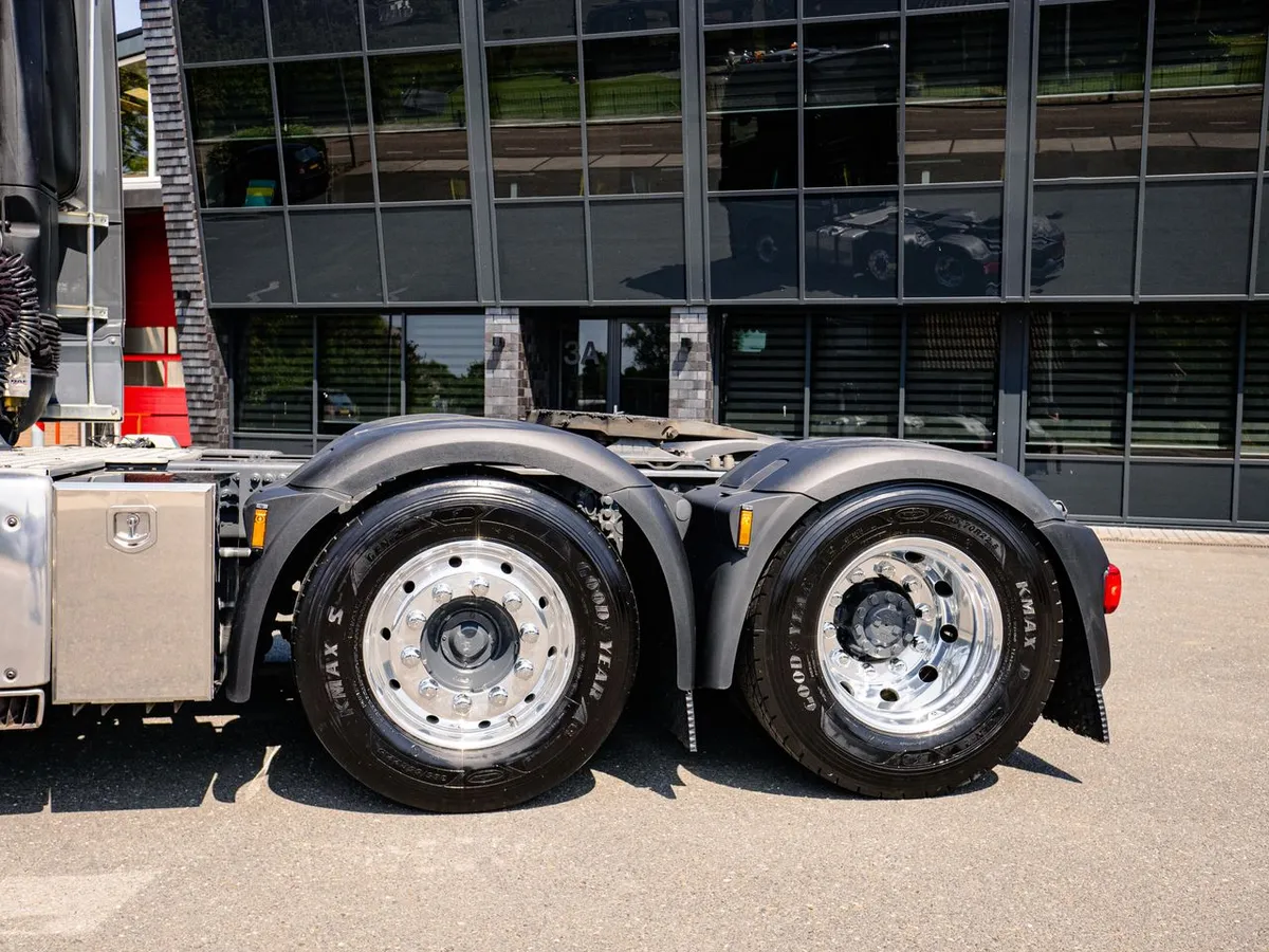 Goodyear KMAX semi-trailer tires on polished chrome wheel rims, tandem axle close-up